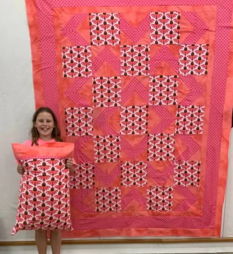 Young quilter with a matching quilt and pillow