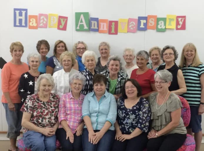 Anniversary group under a handmade banner