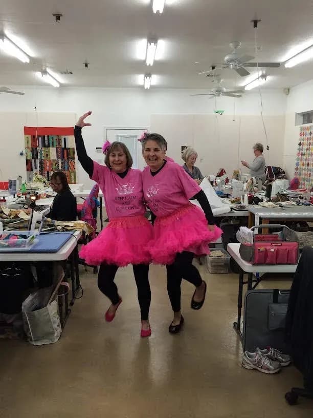 Two guests in matching pink tutus and Keep Calm and Quilt On shirts