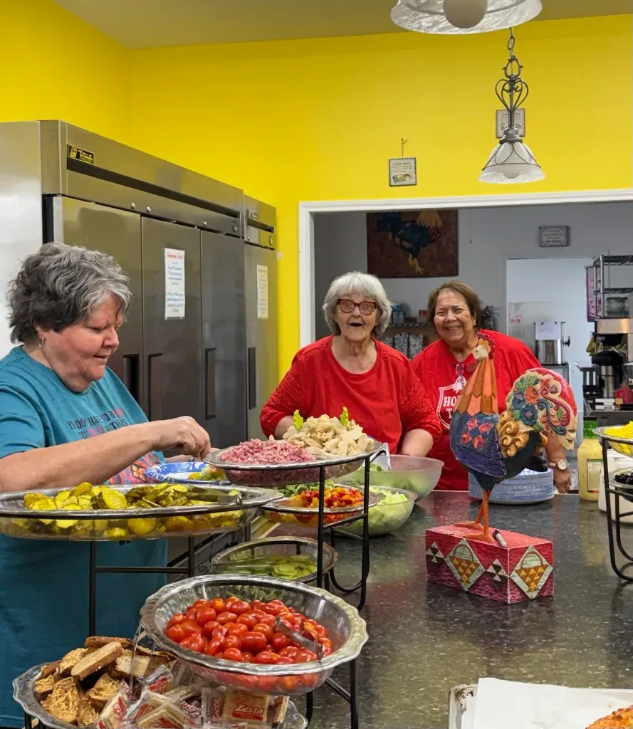 Guests serving themselves at the salad bar