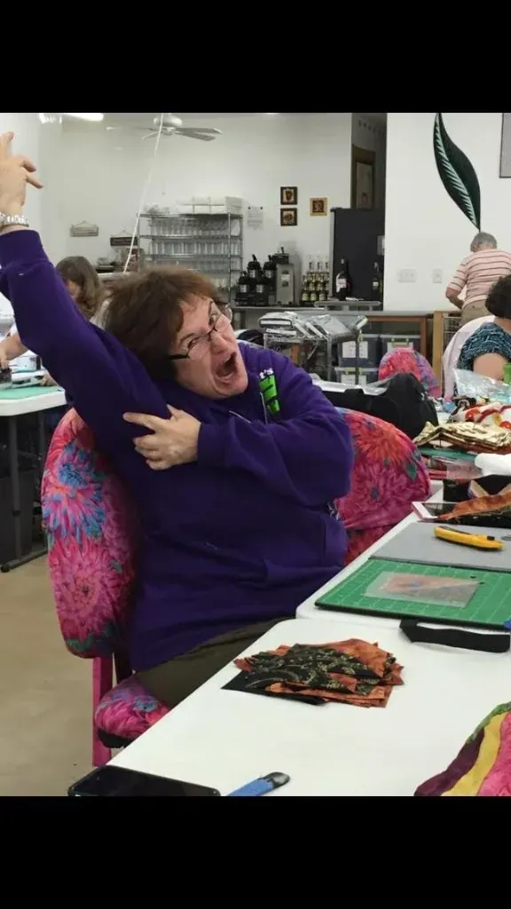 Guest making a playful face at her sewing station