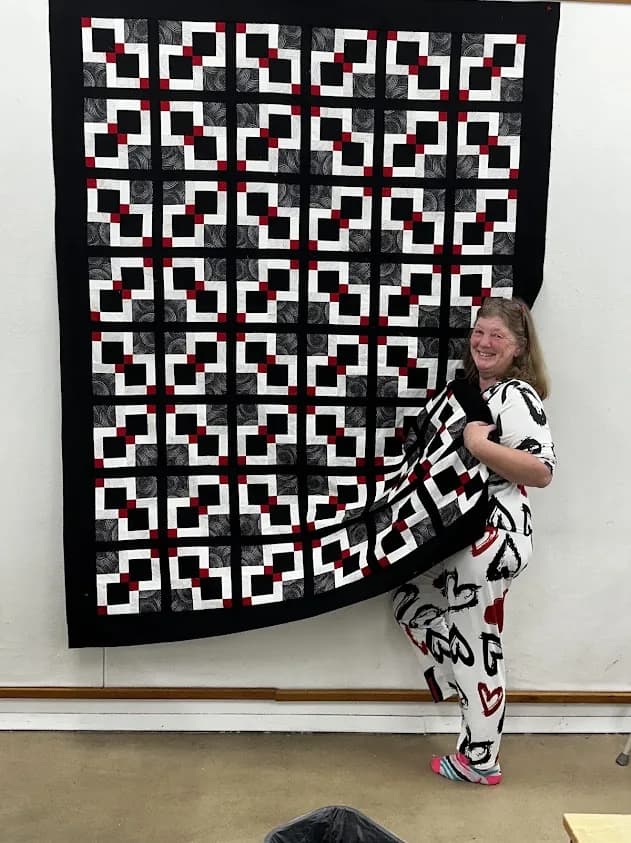 Black, white, and red geometric quilt on the design wall from Shoppe fabric