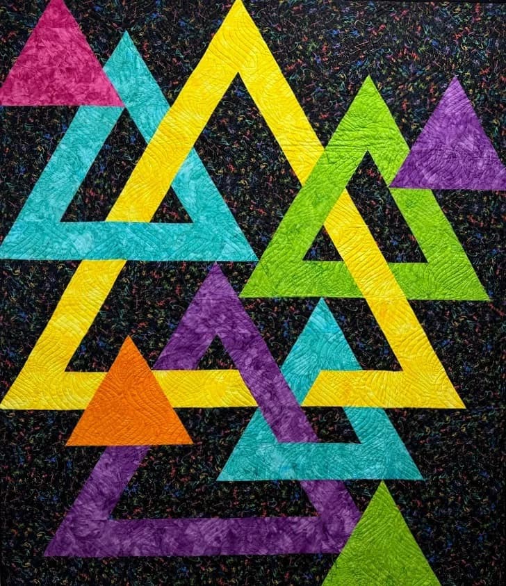 Colorful interlocking triangle quilt on the design wall